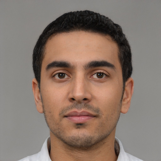 Neutral latino young-adult male with short  black hair and brown eyes