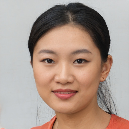 Joyful asian young-adult female with short  black hair and brown eyes