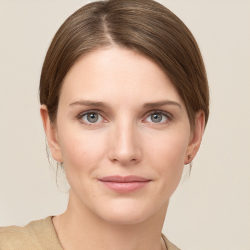 Joyful white young-adult female with medium  brown hair and grey eyes