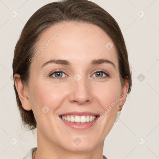 Joyful white young-adult female with medium  brown hair and grey eyes