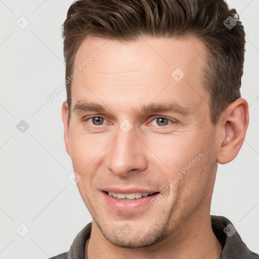 Joyful white adult male with short  brown hair and brown eyes