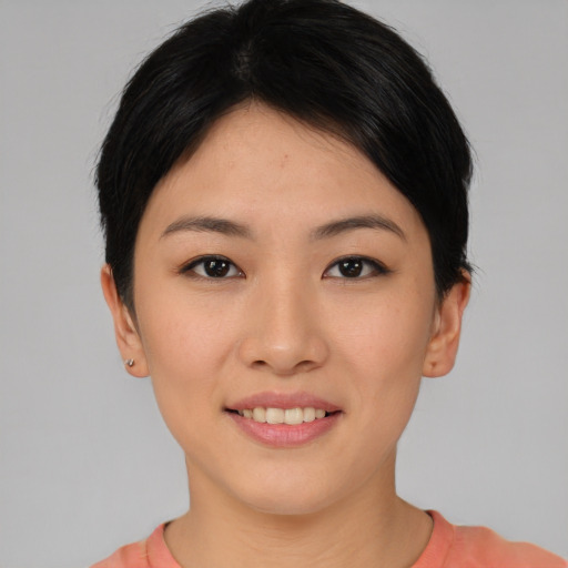 Joyful asian young-adult female with short  black hair and brown eyes