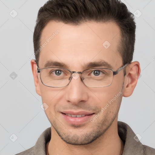 Joyful white adult male with short  brown hair and brown eyes