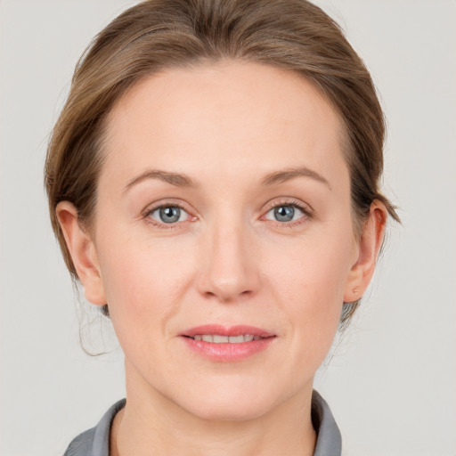 Joyful white young-adult female with medium  brown hair and blue eyes