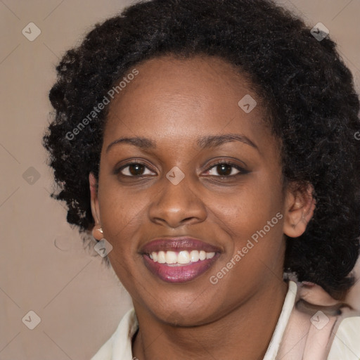 Joyful black young-adult female with long  brown hair and brown eyes