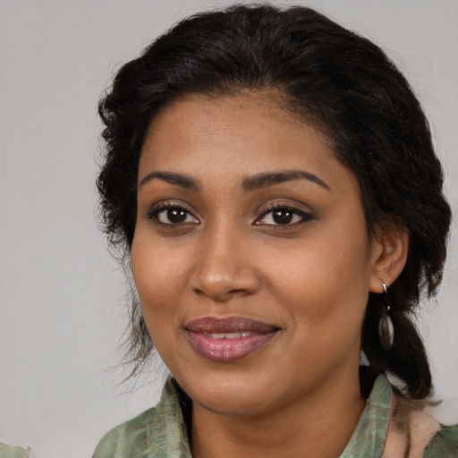 Joyful black young-adult female with medium  brown hair and brown eyes
