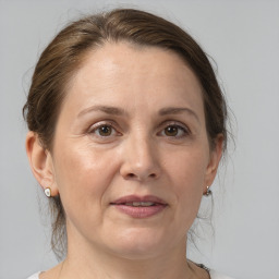 Joyful white adult female with medium  brown hair and grey eyes