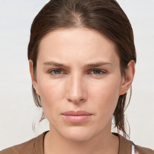 Joyful white young-adult female with medium  brown hair and grey eyes