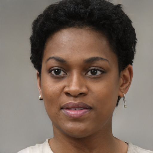 Joyful black young-adult female with short  black hair and brown eyes