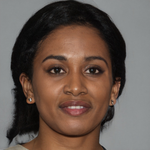 Joyful black young-adult female with medium  black hair and brown eyes