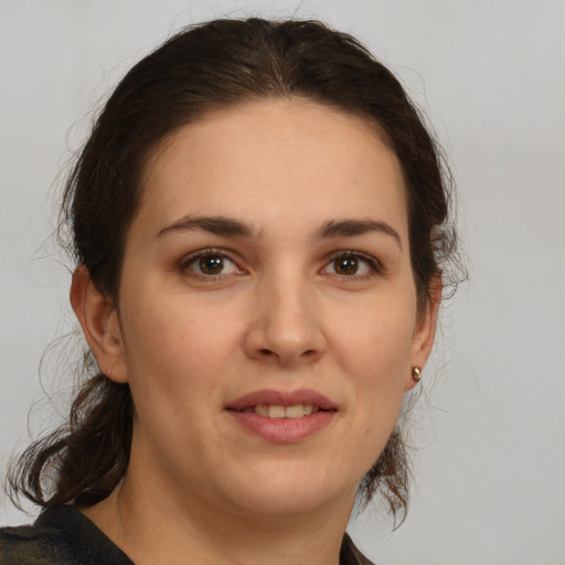 Joyful white young-adult female with medium  brown hair and brown eyes