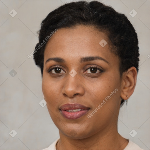 Joyful black young-adult female with short  brown hair and brown eyes