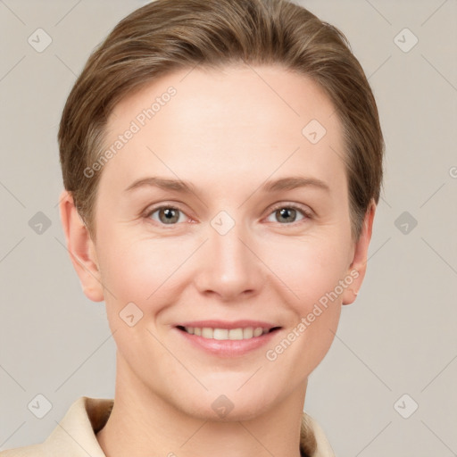 Joyful white young-adult female with short  brown hair and grey eyes