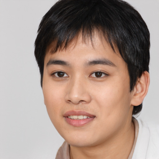 Joyful asian young-adult male with short  black hair and brown eyes