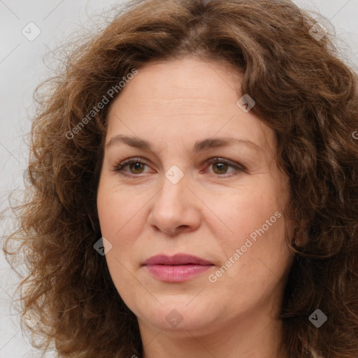 Joyful white adult female with long  brown hair and brown eyes