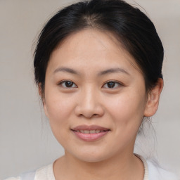 Joyful asian young-adult female with medium  brown hair and brown eyes