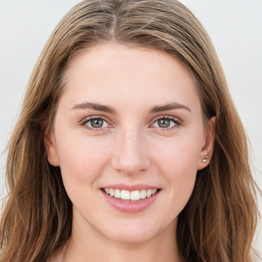 Joyful white young-adult female with long  brown hair and blue eyes