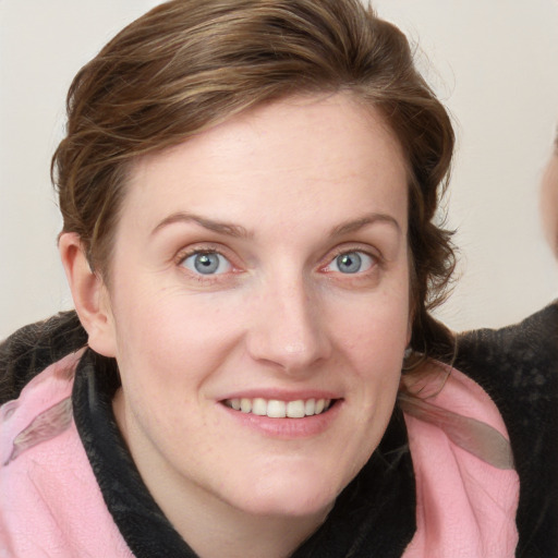 Joyful white young-adult female with medium  brown hair and blue eyes