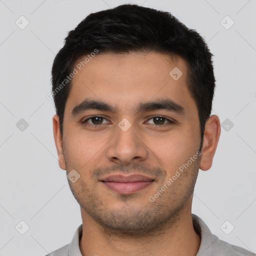 Joyful latino young-adult male with short  black hair and brown eyes