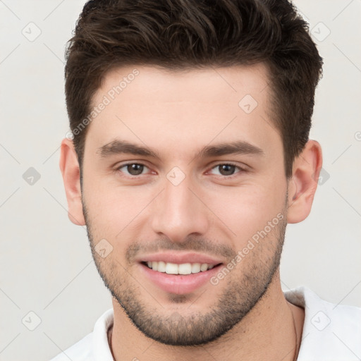 Joyful white young-adult male with short  brown hair and brown eyes