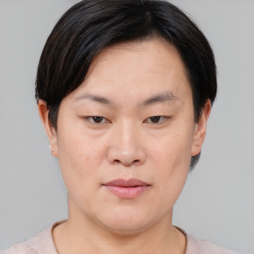Joyful asian young-adult female with short  brown hair and brown eyes