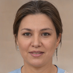 Joyful white adult female with medium  brown hair and brown eyes