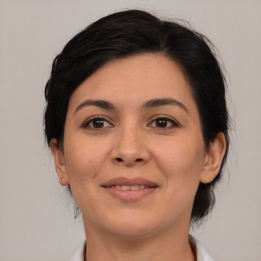 Joyful latino young-adult female with medium  brown hair and brown eyes