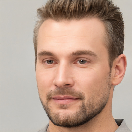 Joyful white young-adult male with short  brown hair and brown eyes