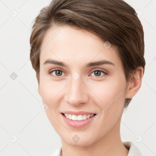 Joyful white young-adult female with short  brown hair and grey eyes