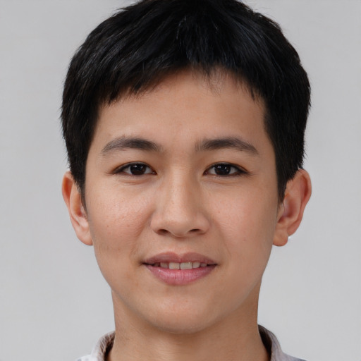 Joyful asian young-adult male with short  brown hair and brown eyes