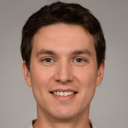 Joyful white adult male with short  brown hair and grey eyes