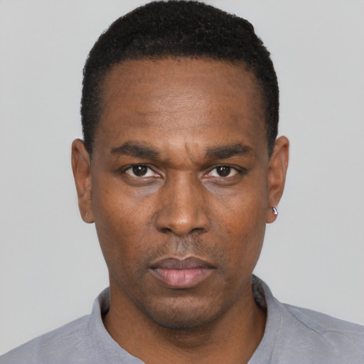Neutral black adult male with short  black hair and brown eyes