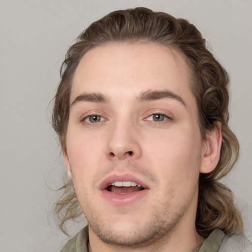 Joyful white young-adult male with medium  brown hair and brown eyes