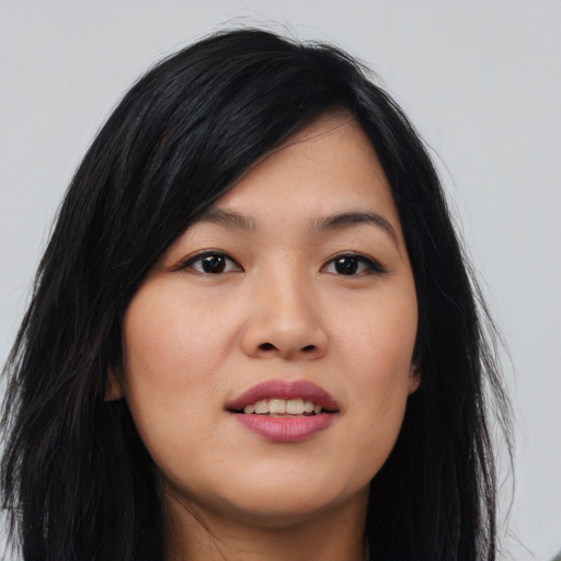 Joyful asian young-adult female with long  black hair and brown eyes