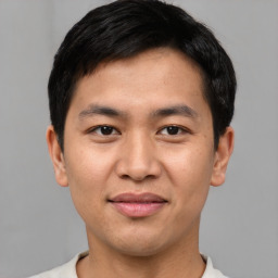 Joyful asian young-adult male with short  black hair and brown eyes