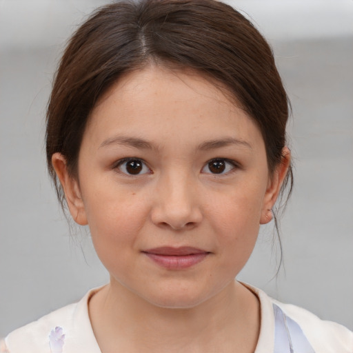 Joyful white child female with medium  brown hair and brown eyes