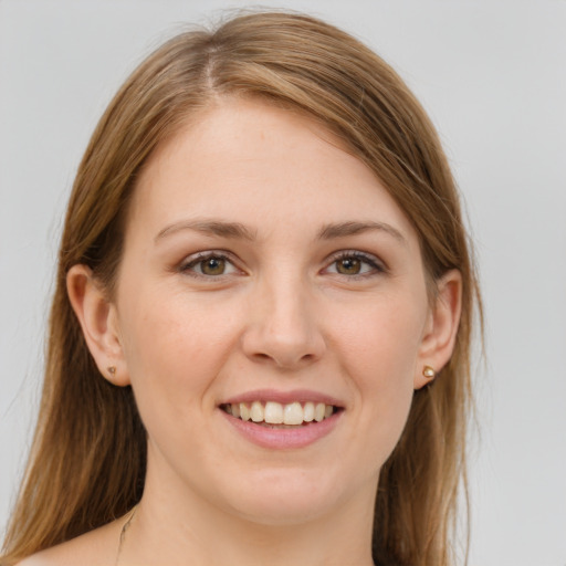 Joyful white young-adult female with long  brown hair and brown eyes