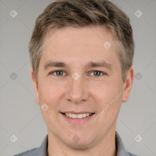 Joyful white adult male with short  brown hair and grey eyes