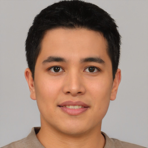 Joyful latino young-adult male with short  black hair and brown eyes