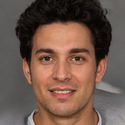 Joyful white young-adult male with short  black hair and brown eyes