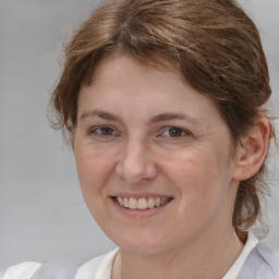 Joyful white adult female with medium  brown hair and brown eyes