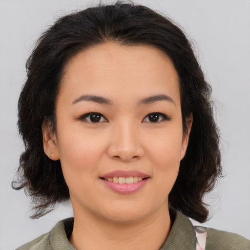 Joyful asian young-adult female with medium  brown hair and brown eyes