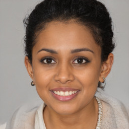 Joyful black young-adult female with medium  brown hair and brown eyes