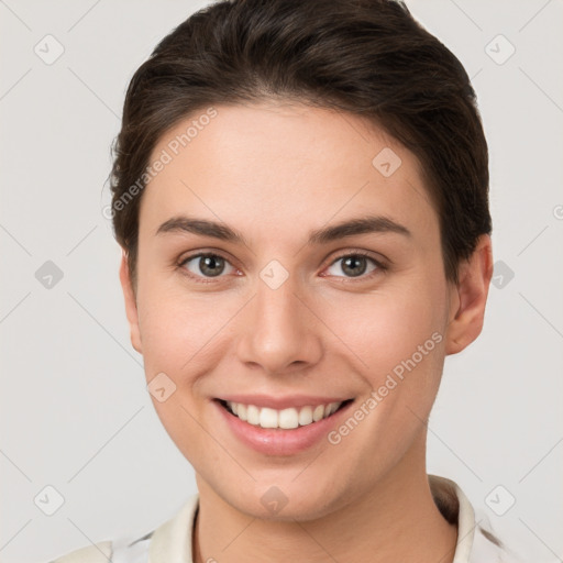 Joyful white young-adult female with short  brown hair and grey eyes