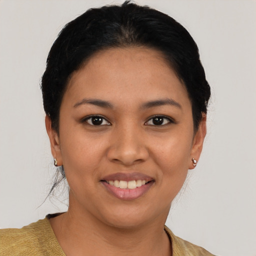 Joyful latino young-adult female with short  black hair and brown eyes