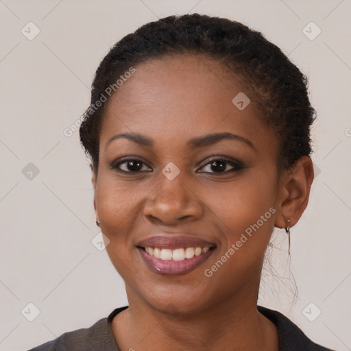 Joyful black young-adult female with short  brown hair and brown eyes