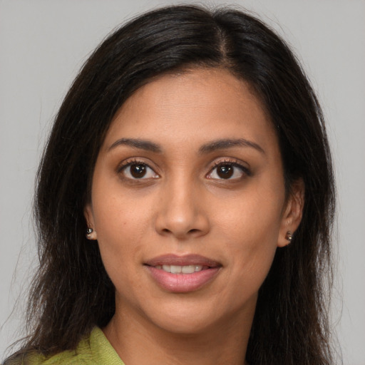 Joyful latino young-adult female with long  brown hair and brown eyes