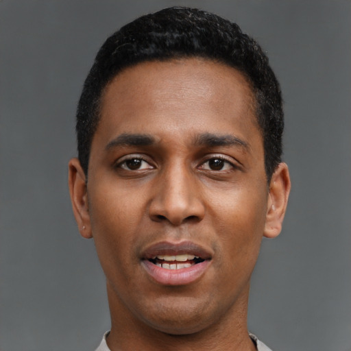 Joyful latino young-adult male with short  black hair and brown eyes