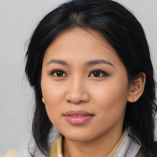Joyful latino young-adult female with long  black hair and brown eyes