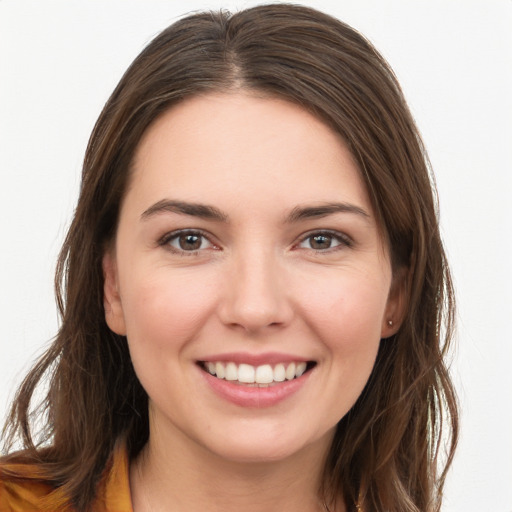 Joyful white young-adult female with long  brown hair and brown eyes